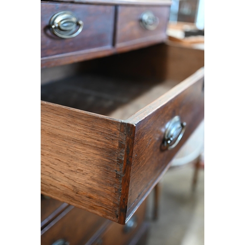 52 - A 19th century oak chest of two short over four long graduating drawers raised on shaped bracket fee... 