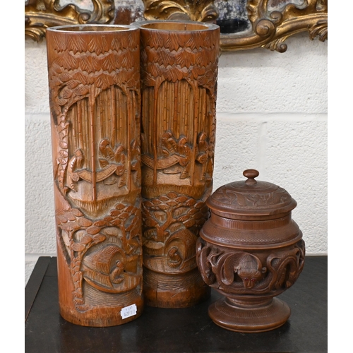 521 - Two Chinese carved bamboo bitong 46 cm high to/w a turned teak tobacco box and cover with brass reli... 