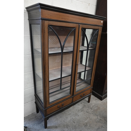 53 - An Edwardian walnut inlaid display cabinet with astragal glazed doors enclosing two shelves over two... 