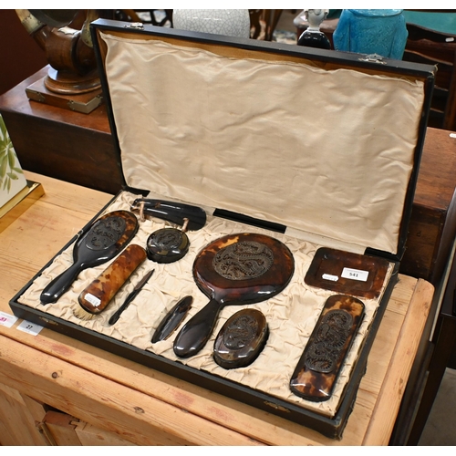 541 - A vintage Chinese tortoiseshell ten-piece dressing table set applied with carved and pierced dragon ... 