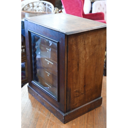 543 - A Victorian stained wood collector's chest of six shallow drawers enclosed by a glazed door, 45 x 38... 