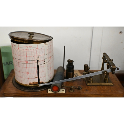 549 - A vintage barograph in glazed oak case, 32 cm wide, to/w two boxes of spare charts and a bottle of i... 