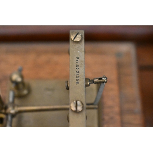 549 - A vintage barograph in glazed oak case, 32 cm wide, to/w two boxes of spare charts and a bottle of i... 