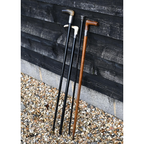 550 - Four silver-mounted walking sticks/canes