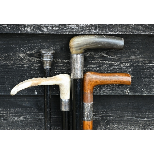 550 - Four silver-mounted walking sticks/canes