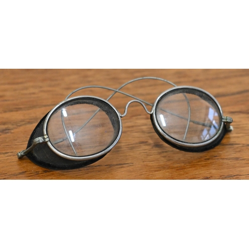 554 - An antique pair of spectacle goggles with velvet-lined mesh side-guards