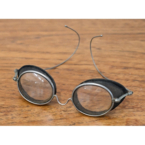 554 - An antique pair of spectacle goggles with velvet-lined mesh side-guards