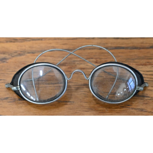 554 - An antique pair of spectacle goggles with velvet-lined mesh side-guards