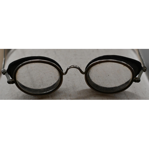 554 - An antique pair of spectacle goggles with velvet-lined mesh side-guards