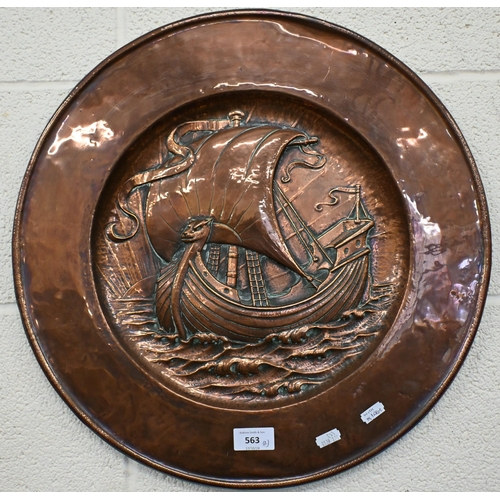 563 - An Arts & Crafts copper charger, embossed with a sailing ship, 46 cm diam to/w a vintage wall mi... 