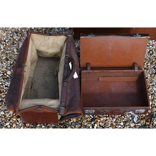 579 - An antique leather Gladstone bag and two vintage leather suitcases (3 - a/f)