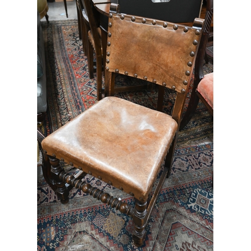 65 - Four oak framed dining chairs with studded brown vinyl backs and seats in the Cromwellian manner (4)