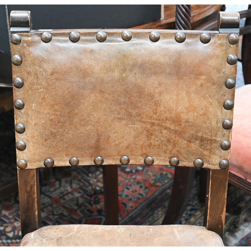 65 - Four oak framed dining chairs with studded brown vinyl backs and seats in the Cromwellian manner (4)