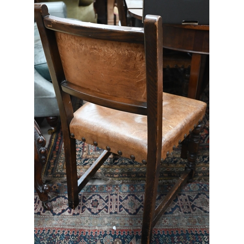 65 - Four oak framed dining chairs with studded brown vinyl backs and seats in the Cromwellian manner (4)