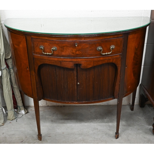 67 - A mahogany demi-lune sideboard with cupboard doors flanking central drawer over sliding tambour door... 