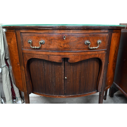 67 - A mahogany demi-lune sideboard with cupboard doors flanking central drawer over sliding tambour door... 