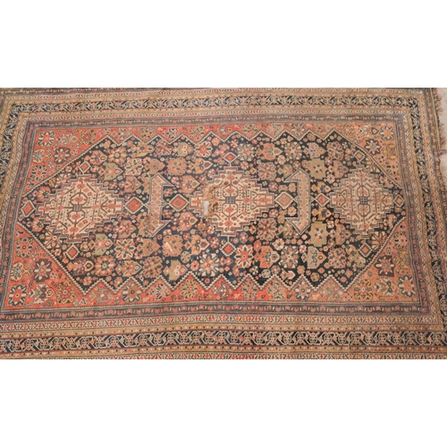 73 - An antique Persian Qashai kelleigh rug, stylised design on navy ground with repeating borders, 266 x... 