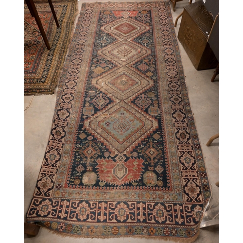 73 - An antique Persian Qashai kelleigh rug, stylised design on navy ground with repeating borders, 266 x... 