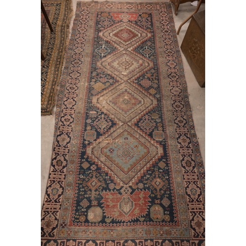 73 - An antique Persian Qashai kelleigh rug, stylised design on navy ground with repeating borders, 266 x... 