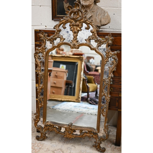 77 - A Chippendale style mirror with antiqued glass and decorative foliate gilt frame, a/f