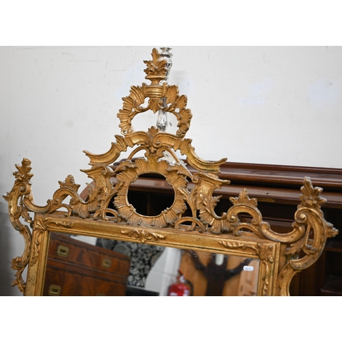 78 - An Italian reproduction mirror in decorative foliate carved gilt frame in 18th century manner, 100 c... 