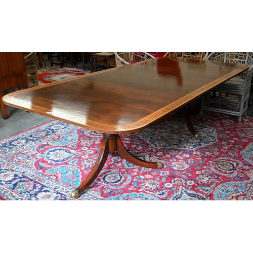 79 - A good quality reproduction extending dining table, the rounded rectangular mahogany top with satin ... 