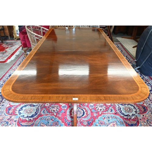 79 - A good quality reproduction extending dining table, the rounded rectangular mahogany top with satin ... 