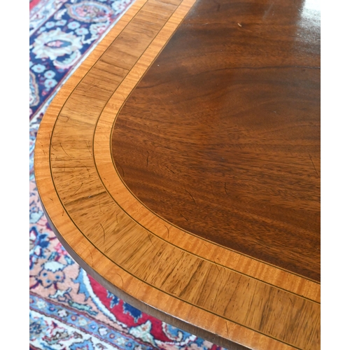 79 - A good quality reproduction extending dining table, the rounded rectangular mahogany top with satin ... 