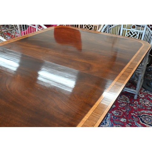 79 - A good quality reproduction extending dining table, the rounded rectangular mahogany top with satin ... 