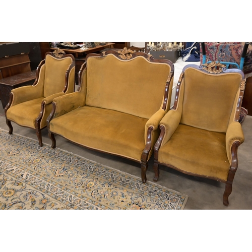 83 - An early 20th century mahogany and gilt framed salon suite in old gold dralon upholstery comprising ... 