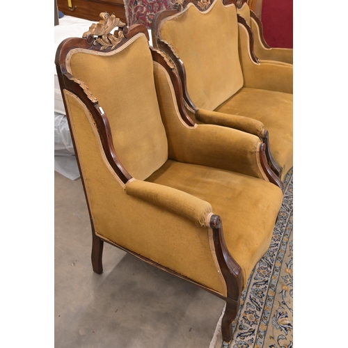 83 - An early 20th century mahogany and gilt framed salon suite in old gold dralon upholstery comprising ... 