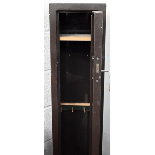 87 - A Moutain and Sowden Ltd (West Yorkshire) brown steel twin lock three gun cabinet (key with office),... 