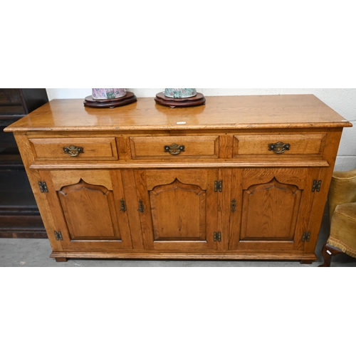 9 - A good quality reproduction oak dresser with three drawers over three panelled cupboards, in the 18t... 