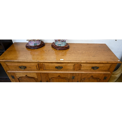 9 - A good quality reproduction oak dresser with three drawers over three panelled cupboards, in the 18t... 