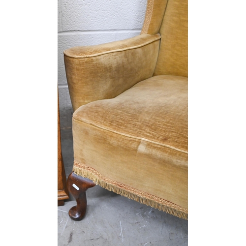 94 - An Edwardian wingback armchair with cabriole front legs, old gold dralon upholstery