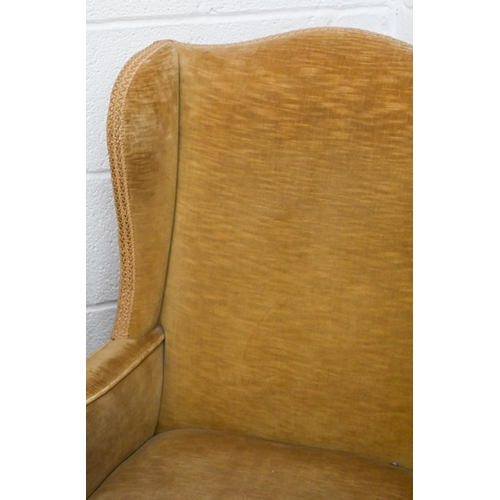 94 - An Edwardian wingback armchair with cabriole front legs, old gold dralon upholstery