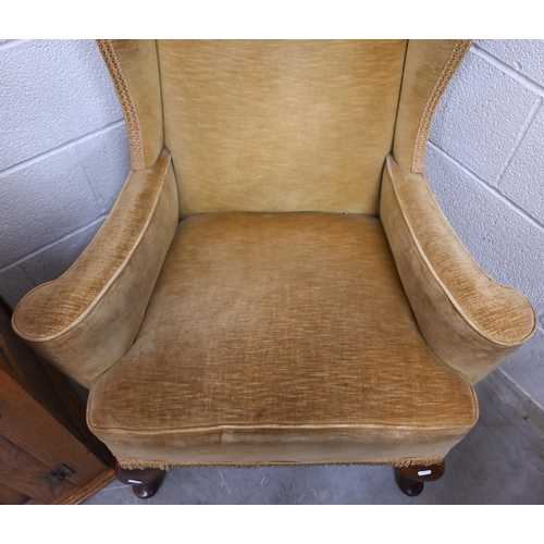 94 - An Edwardian wingback armchair with cabriole front legs, old gold dralon upholstery