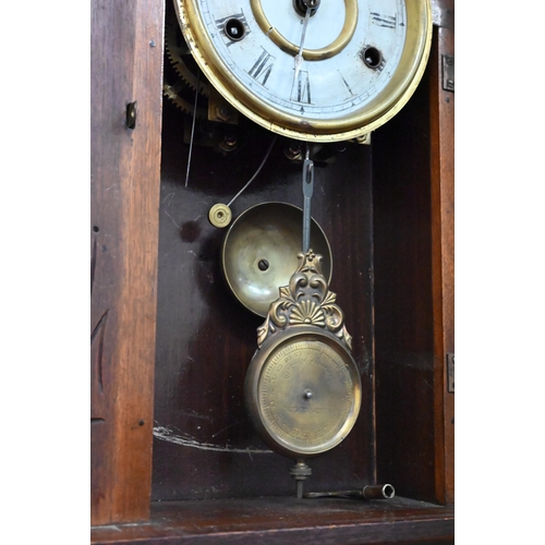 96 - An antique American 'gingerbread' mantel clock with eight-day twin train movement striking on bell c... 