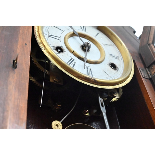 96 - An antique American 'gingerbread' mantel clock with eight-day twin train movement striking on bell c... 