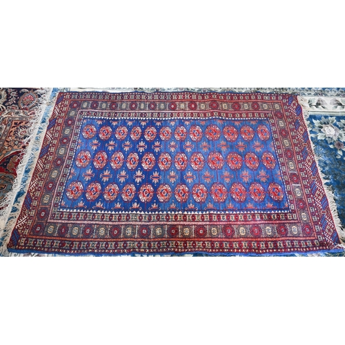 98 - A Pakistani Turkoman design blue ground rug with repeating teke gul design, 190 x 128 cm