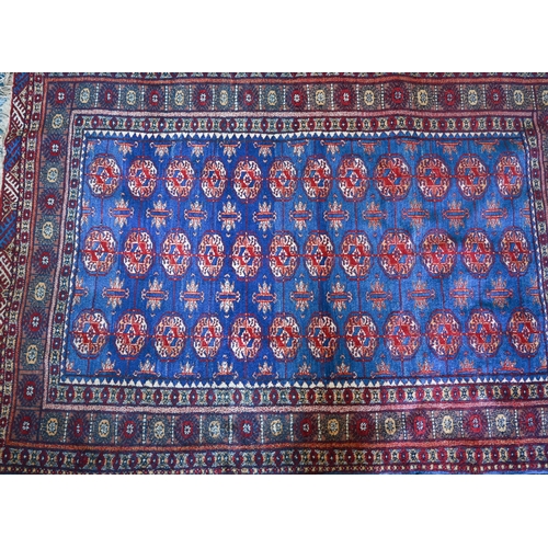 98 - A Pakistani Turkoman design blue ground rug with repeating teke gul design, 190 x 128 cm