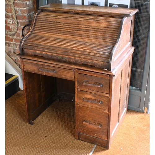 10 - An early 20th century oak tambour roll top desk, 92 cm w x 66 cm d x 112 cm h