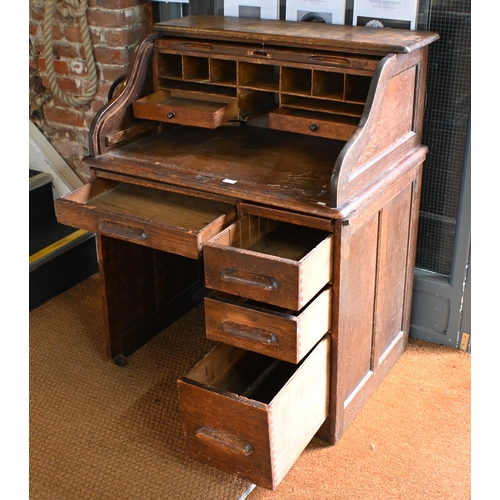 10 - An early 20th century oak tambour roll top desk, 92 cm w x 66 cm d x 112 cm h