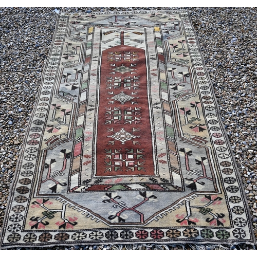 183 - An old golden ground washed Afghan rug, with three rows of stylised guls, 190 cm x 110 cm to/with an... 