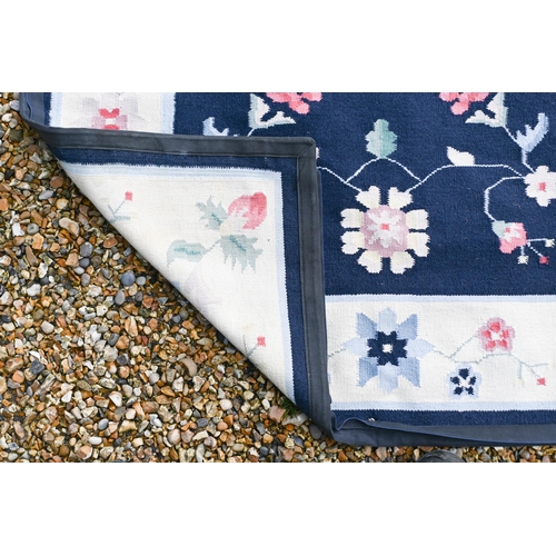 190 - # A blue ground floral rug with cream borders, 182 x 129 cm