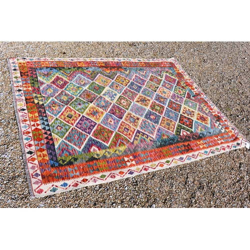 A contemporary Anatolian Turkish kelim carpet, multi-coloured geometric design, 252 cm x 214 cm