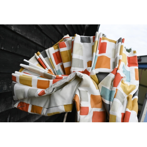 475 - The Design Service - A pair of Scion fabric curtains of multi-coloured geometric shapes on a cream g... 