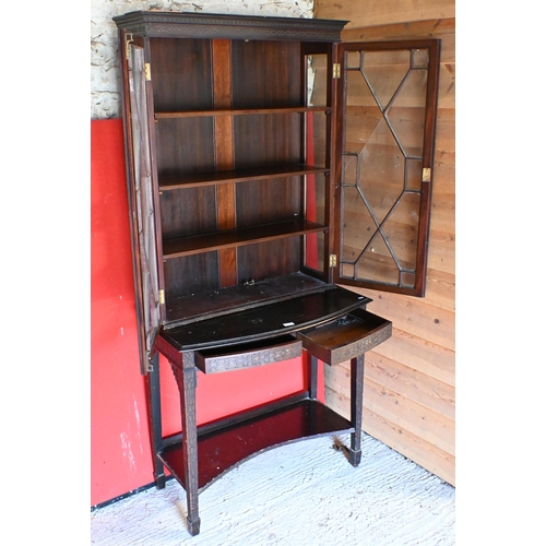 55 - A mahogany Chippendale style curio cabinet with bind fret-cut decoration on bow-fronted two drawer b... 