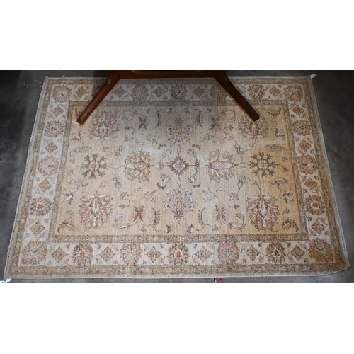 95 - An Indian Agra Ziegler design rug, camel ground with floral design, lighter palmette border, 180 x 1... 