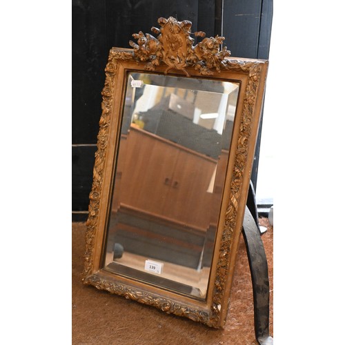 139 - A bevelled wall mirror in giltwood and gesso frame with female portrait crest, 35 x 55 cm to/w inlai... 